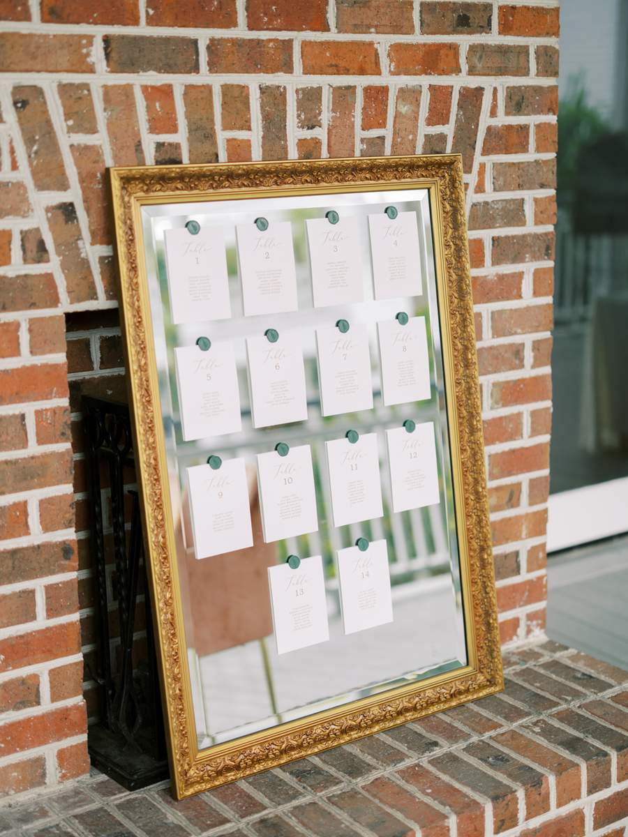Large gold mirror used as seating chart display